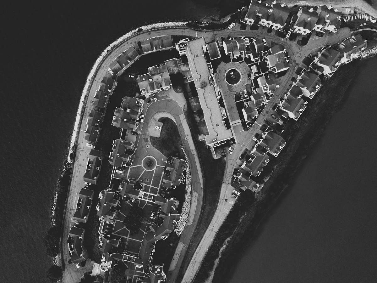 black-and-white grayscale aerial photography of city islet grey